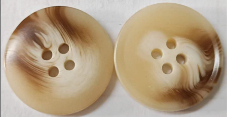 Resin garment buttons with horn-look color and pattern effects