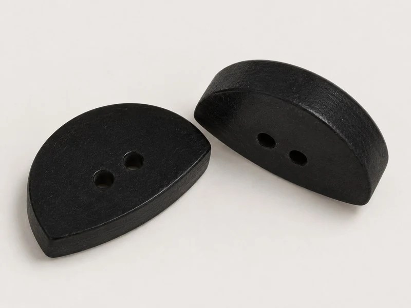 KNC008 black horn buttons with an angular outline and two sewing holes.